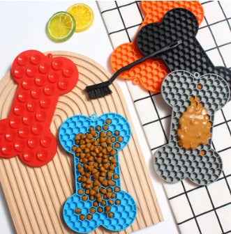 Dog Lick Mat in a bone shape made of black food-grade silicone, perfect for slowing down fast eaters. - Whiskerwise
