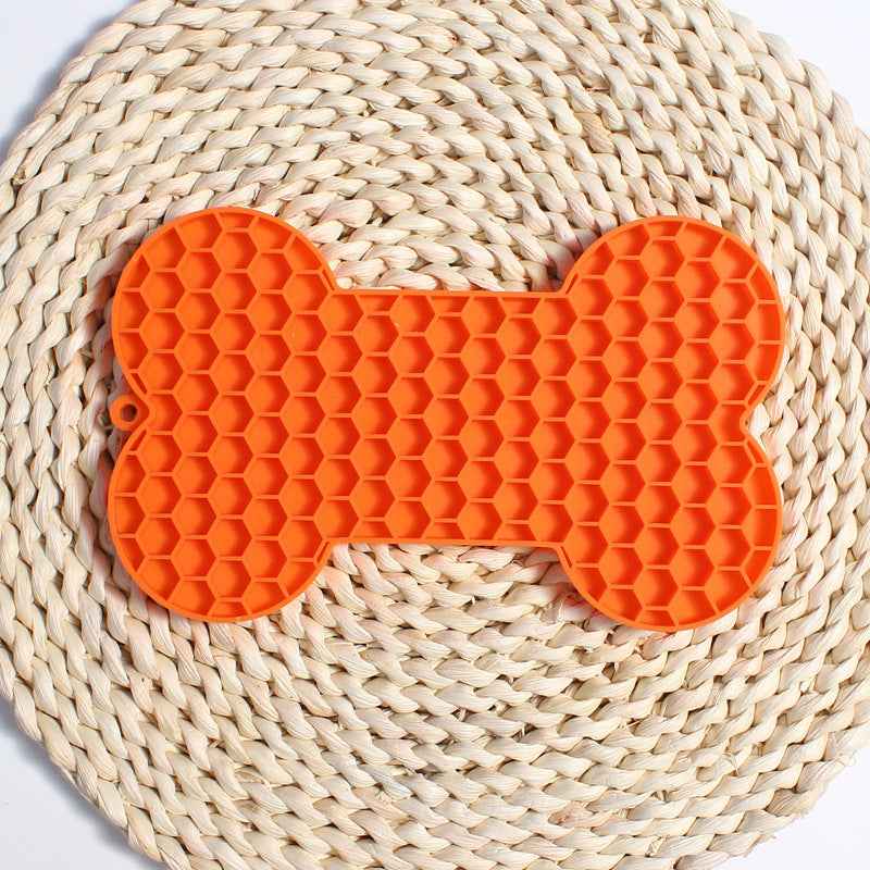 Dog Lick Mat in a bone shape made of black food-grade silicone, perfect for slowing down fast eaters. - Whiskerwise