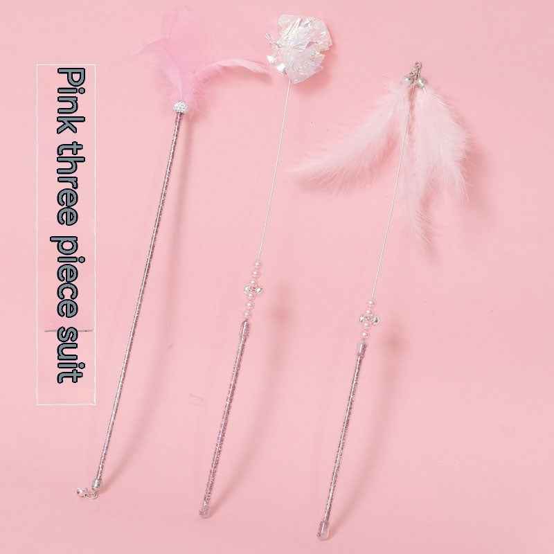 Cat Wand Toy Set – Cat playing with colorful feather on a wand toy while sitting on a chair. - Whiskerwise