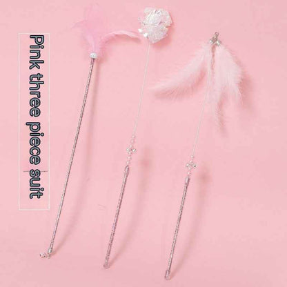 Cat Wand Toy Set – Cat playing with colorful feather on a wand toy while sitting on a chair. - Whiskerwise