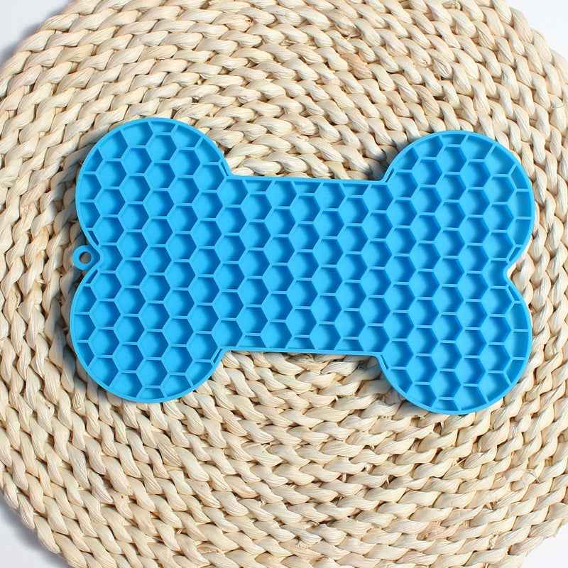 Dog Lick Mat in a bone shape made of black food-grade silicone, perfect for slowing down fast eaters. - Whiskerwise