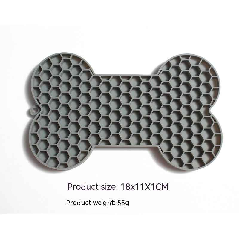 Dog Lick Mat in a bone shape made of black food-grade silicone, perfect for slowing down fast eaters. - Whiskerwise