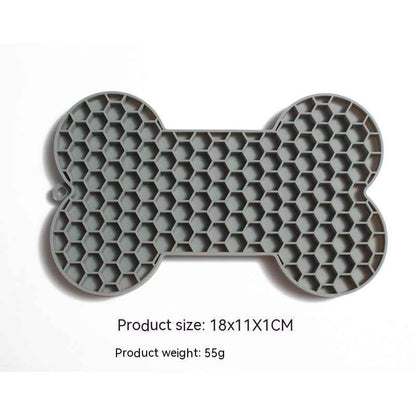 Dog Lick Mat in a bone shape made of black food-grade silicone, perfect for slowing down fast eaters. - Whiskerwise